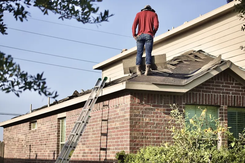 Professional roofer working on a residential roof in The Ranches